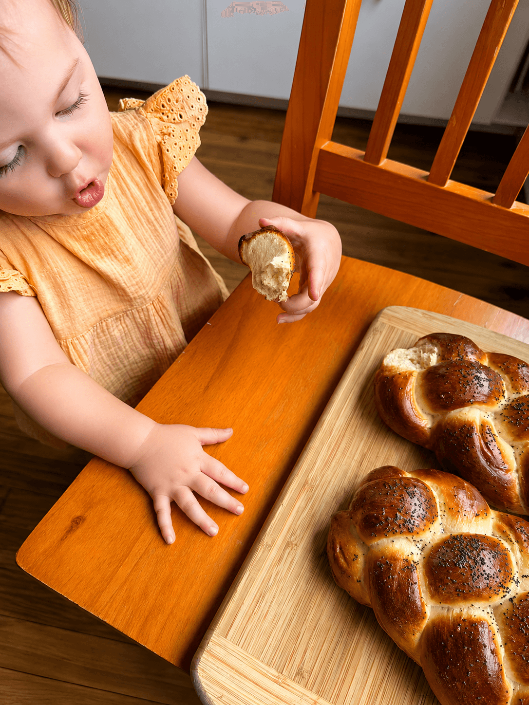 Kara's daughter enjoying freshly baked challah bread