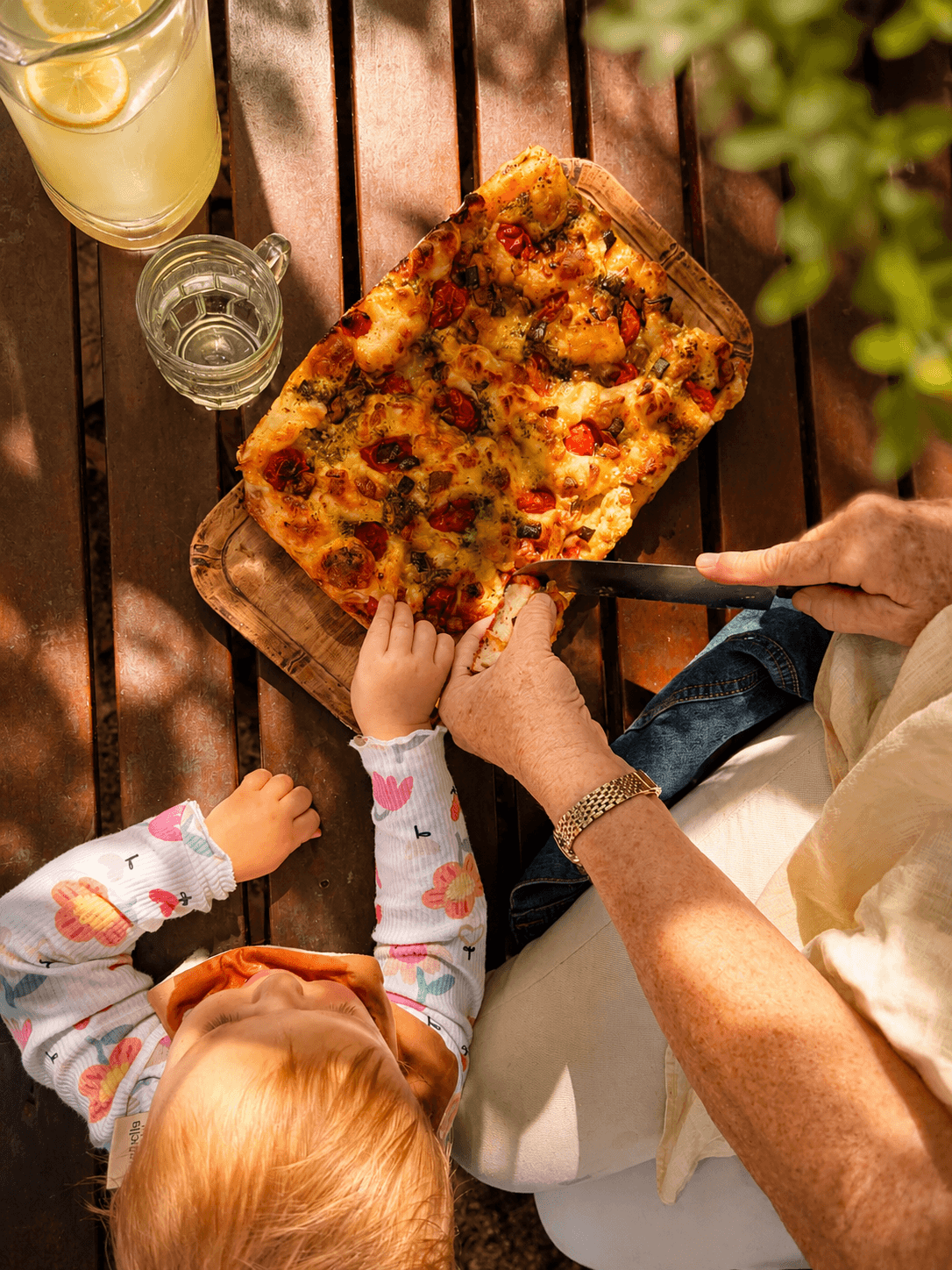 Kara and her daughter sharing food outdoors
