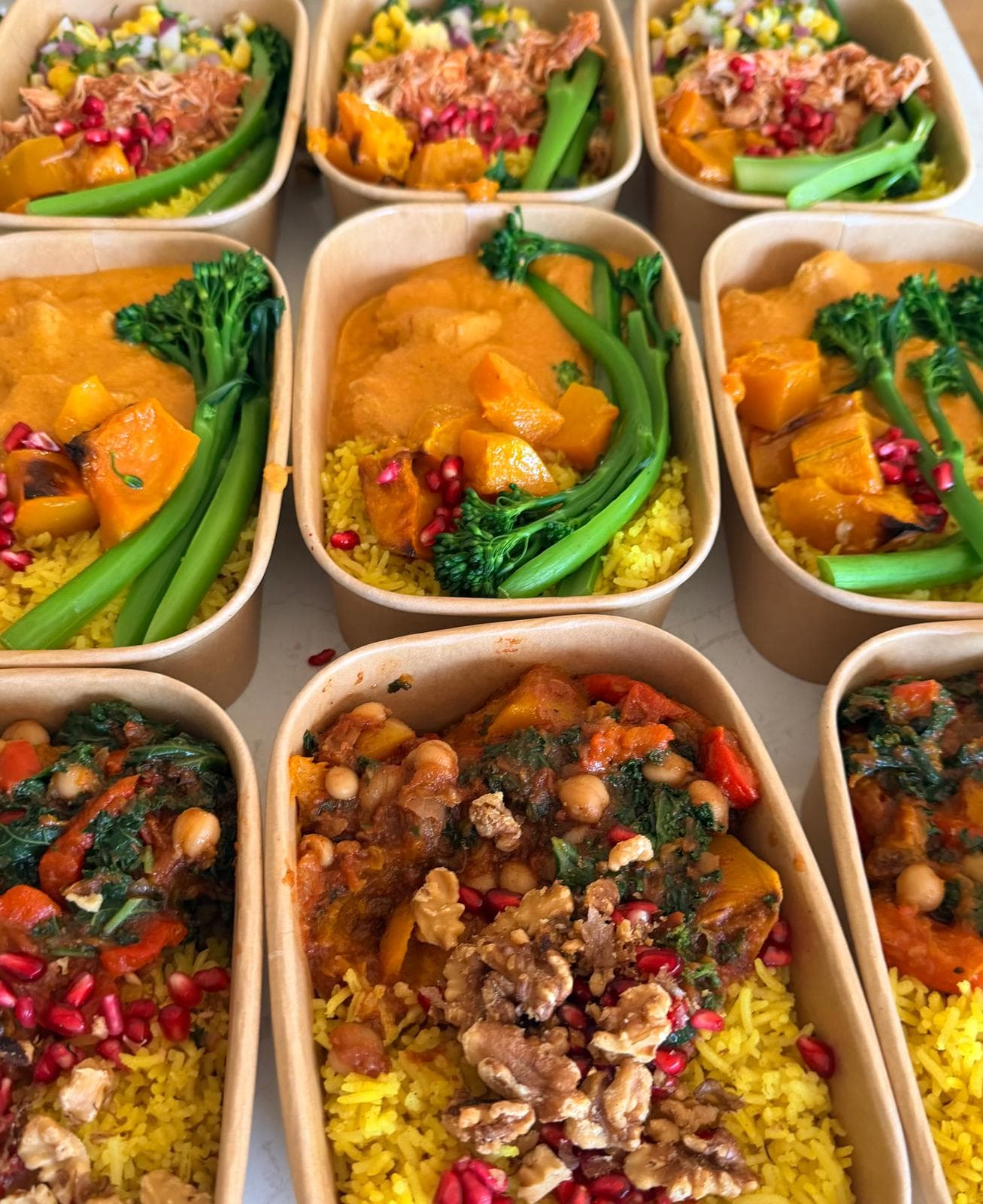 Meal prep containers with turmeric rice, pumpkin curry and broccolini